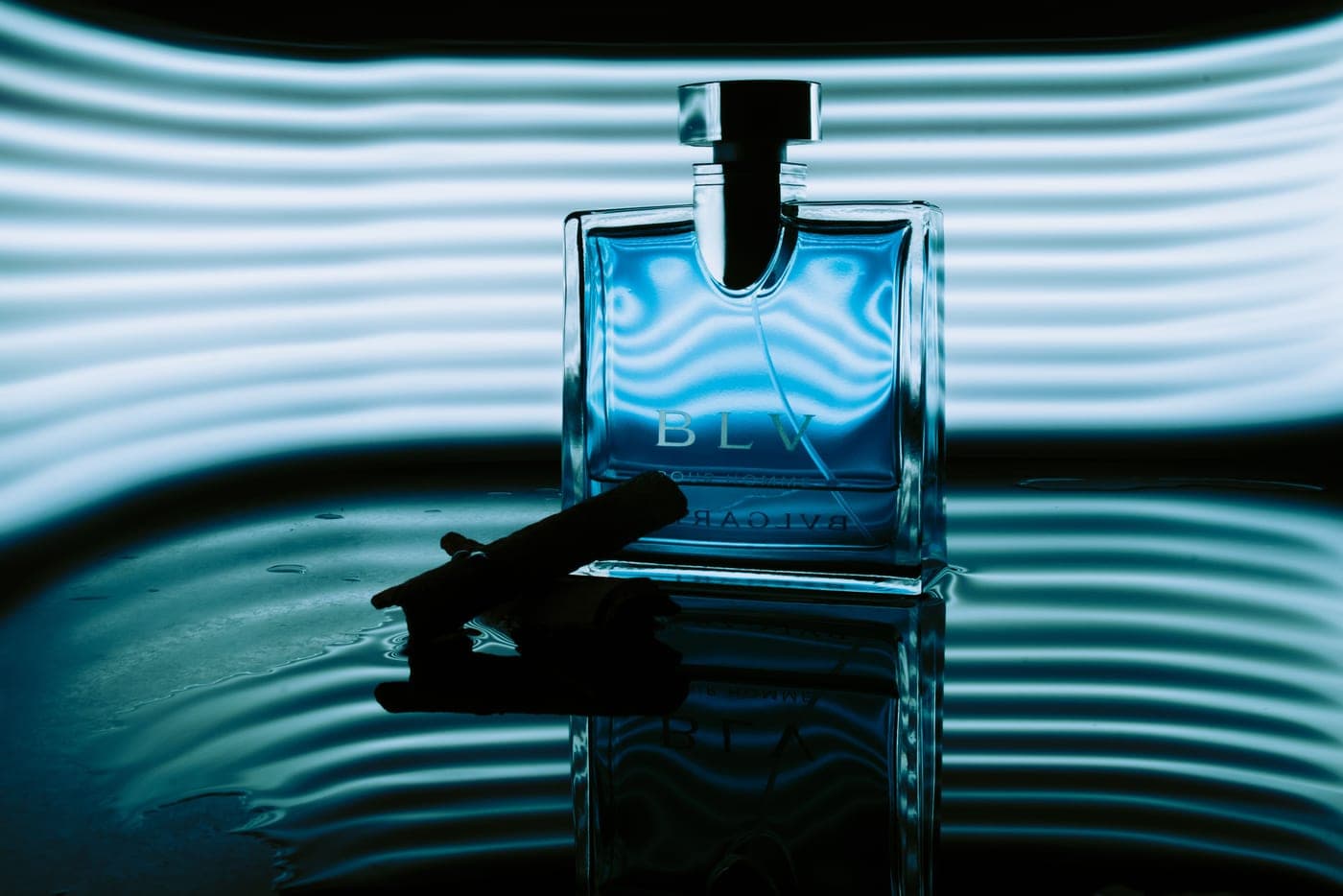 Cologne bottles in warm, natural, directional light on a paper surface